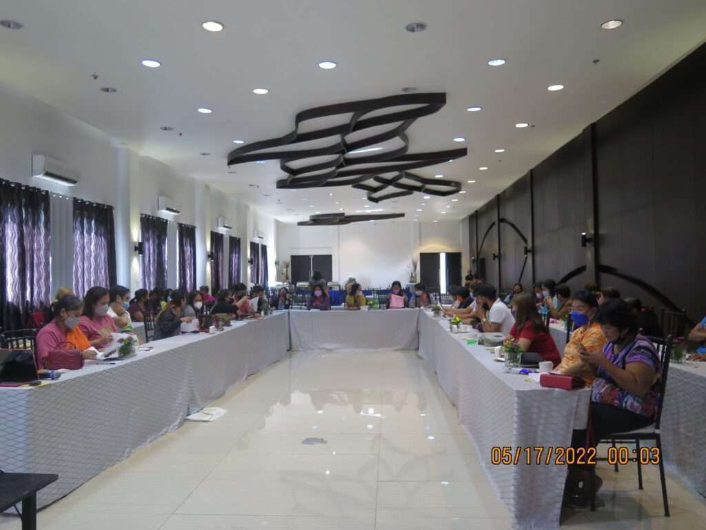 people seated at tables in a meeting room
