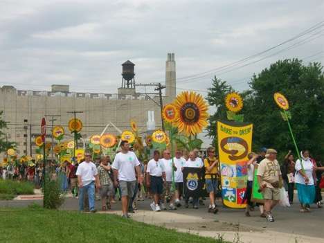 protesters marching with signs and sunflowers